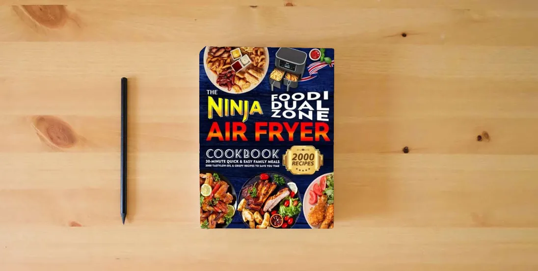 The book The Ninja Foodi Dual Zone Air Fryer Cookbook: 30-minute Quick & Easy Family Meals | 2000 Tasty, Low-Oil & Crispy Recipes to Save You Time} is on the table