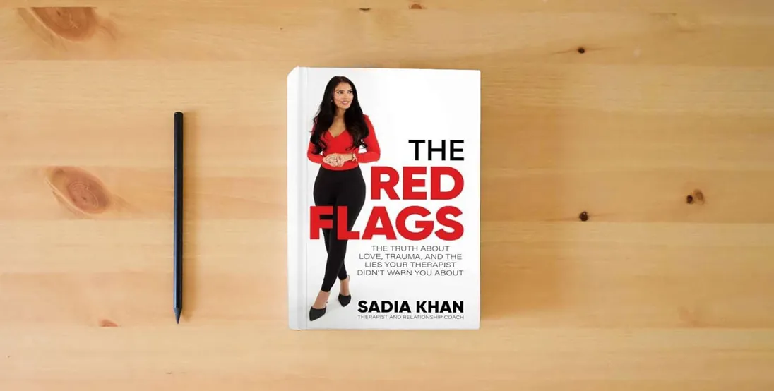 The book The Red Flags: The Truth About Love, Trauma, and the Lies Your Therapist Didn't Warn You About} is on the table