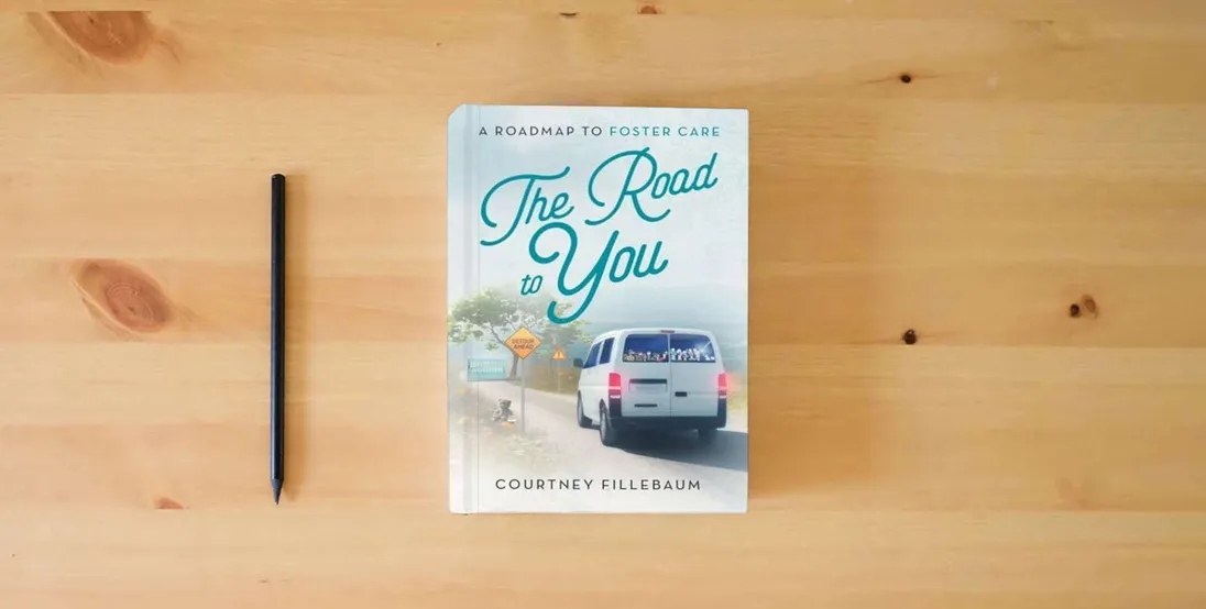 The book The Road to You: A Roadmap to Foster Care} is on the table