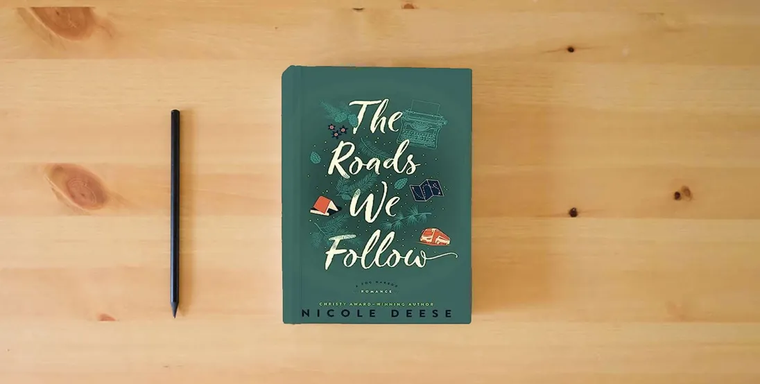 The book The Roads We Follow: (A Feel Good Contemporary Family Drama Romance Novel) (A Fog Harbor Romance)} is on the table
