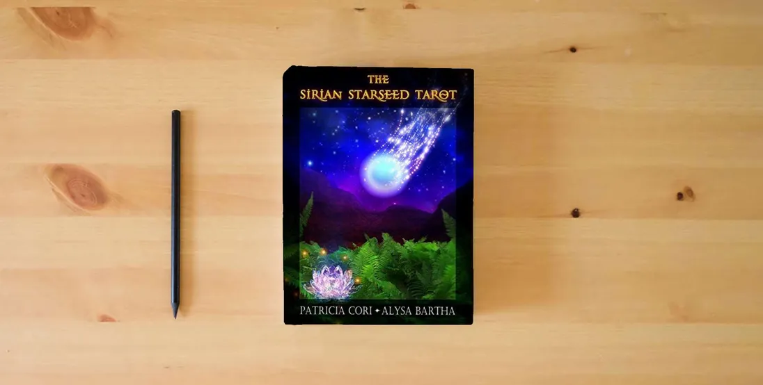 The book The Sirian Starseed Tarot} is on the table