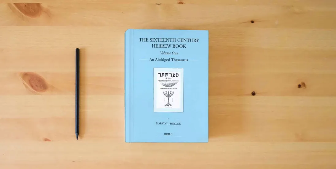 The book The Sixteenth Century Hebrew Book (2 Vols): An Abridged Thesaurus (Brill's Jewish Studies)} is on the table