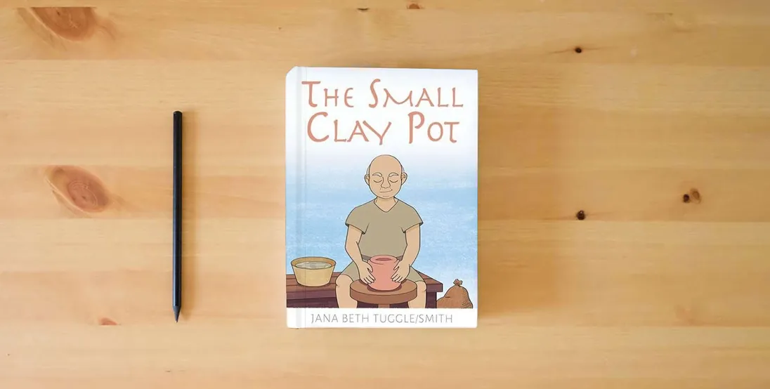 The book The Small Clay Pot} is on the table