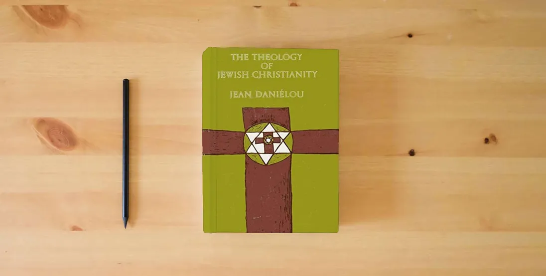 The book The Theology of Jewish Christianity [The Development of Christian Doctrine Before the Council of Nicaea, Volume 1]} is on the table