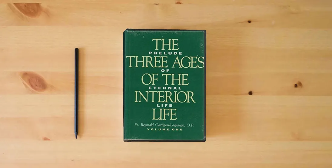 The book The Three Ages of the Interior Life: Prelude of Eternal Life (2 Volume Set)} is on the table