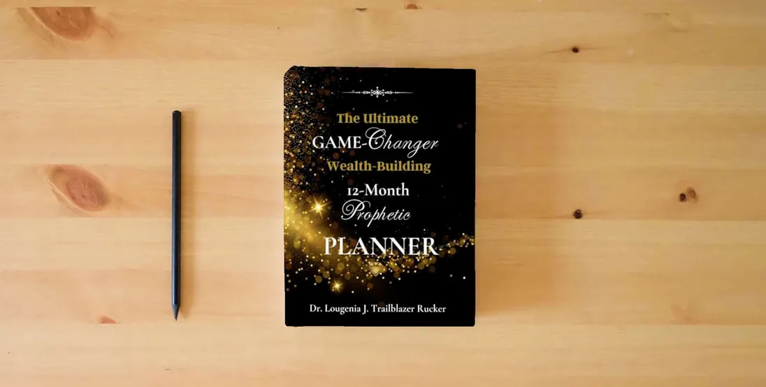 The book The Ultimate Game-Changer Wealth-Building 12-Month Prophetic Planner} is on the table