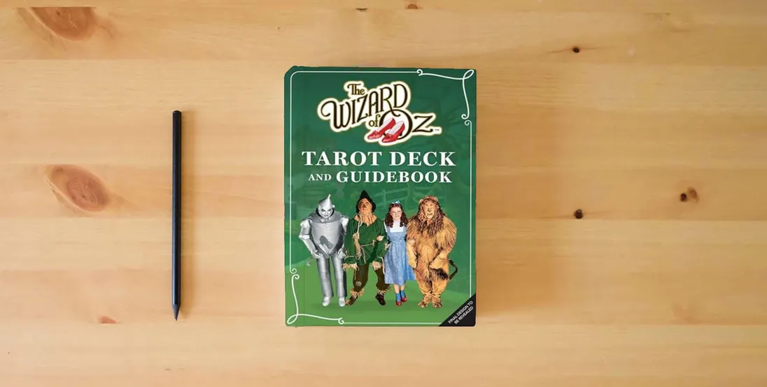 The book The Wizard of Oz Tarot Deck and Guidebook (Tarot/Oracle Decks)} is on the table