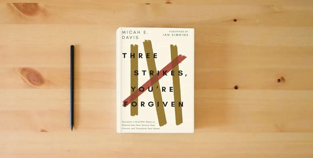 The book Three Strikes, You're Forgiven: Encounter a God Who Wants to Redeem Your Past, Restore Your Present, and Transform Your Future} is on the table