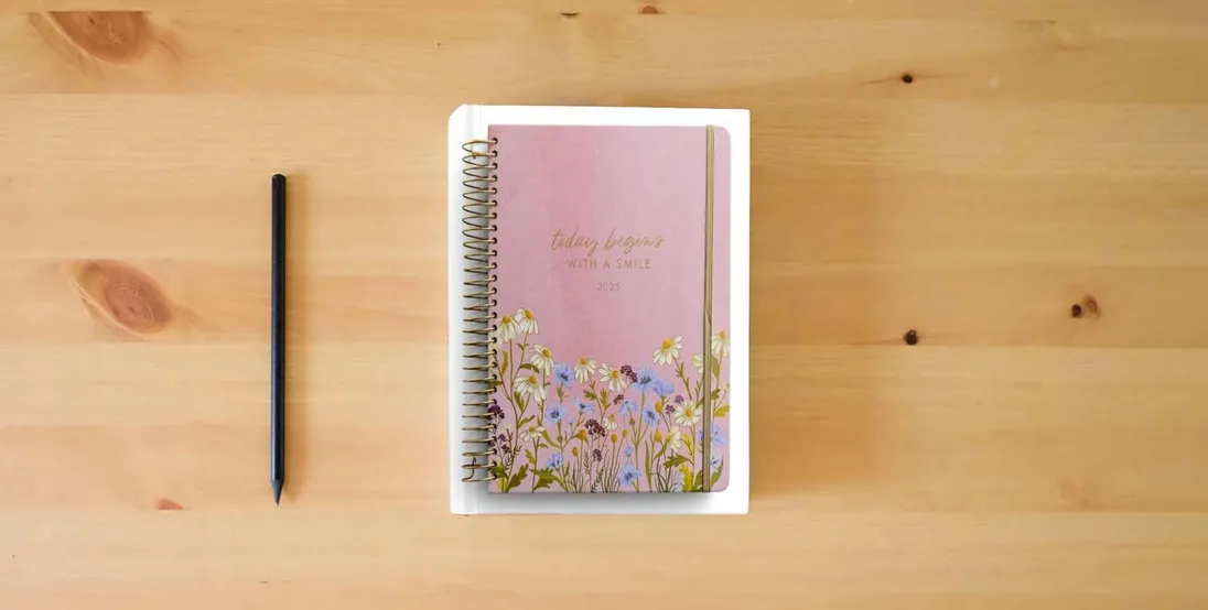 The book Today Begins With a Smile: 2024 - 2025 Studio 71 Planner - 18 Month Devotional Planner (July 2024 - December 2025)} is on the table