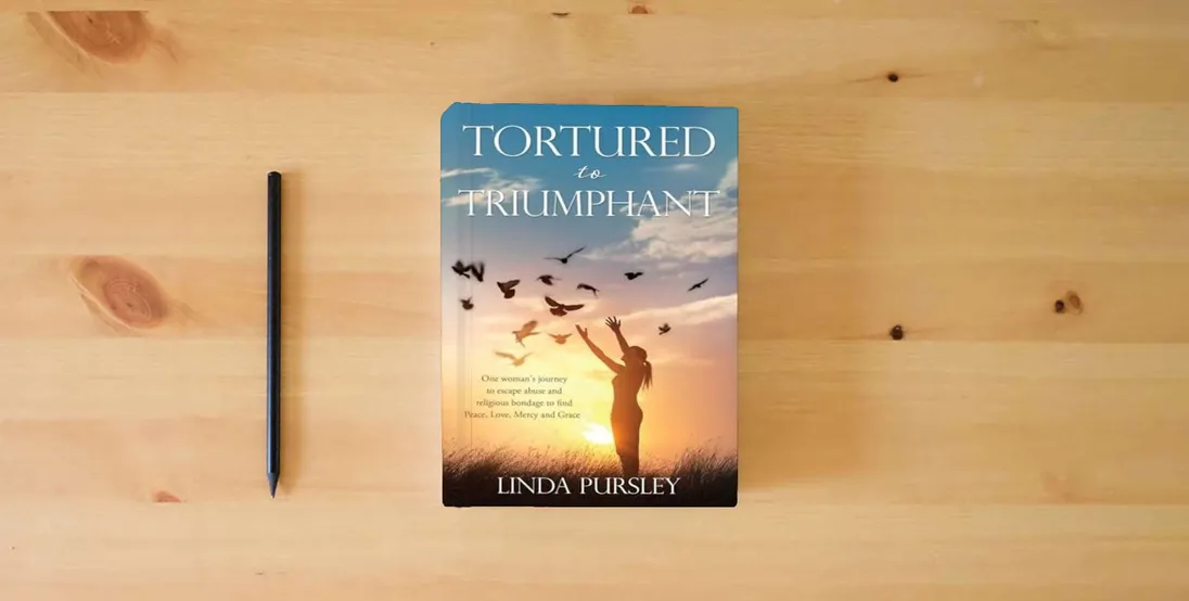 The book Tortured to Triumphant} is on the table