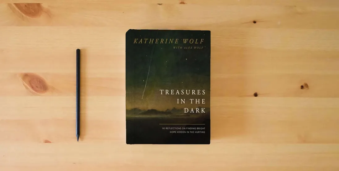 The book Treasures in the Dark: 90 Reflections on Finding Bright Hope Hidden in the Hurting} is on the table
