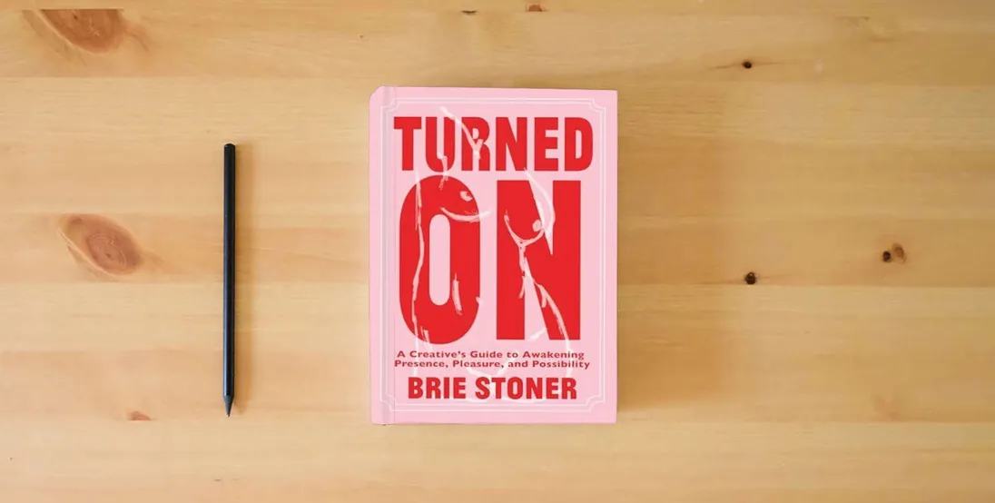 The book Turned On: A Creative’s Guide to Awakening Presence, Pleasure, and Possibility} is on the table