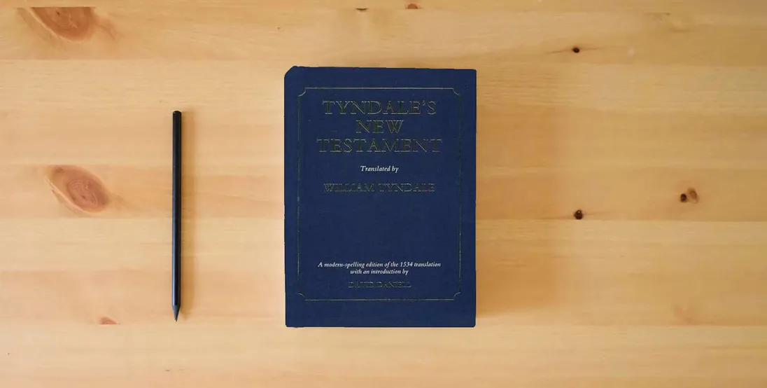 The book Tyndale's New Testament} is on the table