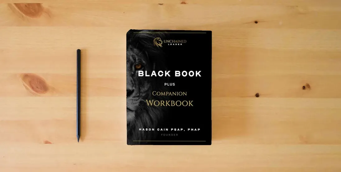 The book Unchained Leader Black Book + Companion Workbook: Blackout Edition} is on the table