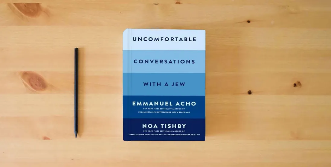 The book Uncomfortable Conversations with a Jew} is on the table