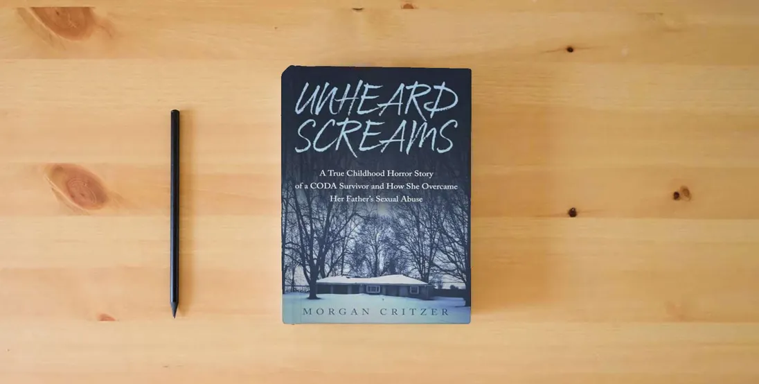 The book Unheard Screams: A True Childhood Horror Story of a CODA Survivor and How She Overcame Her Father's Sexual Abuse} is on the table
